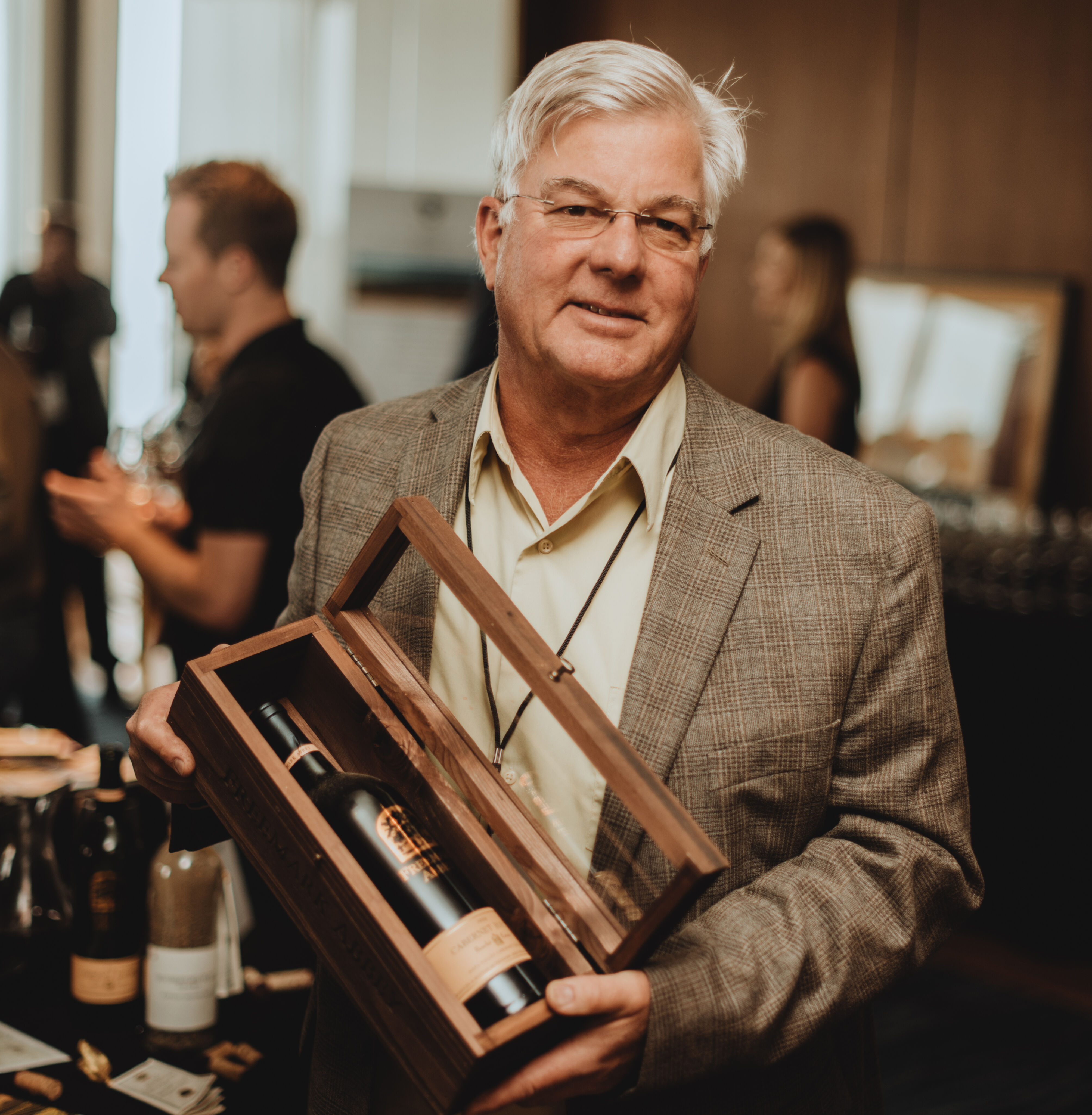 Ted Edwards holding a box with Freemark Abbey wine