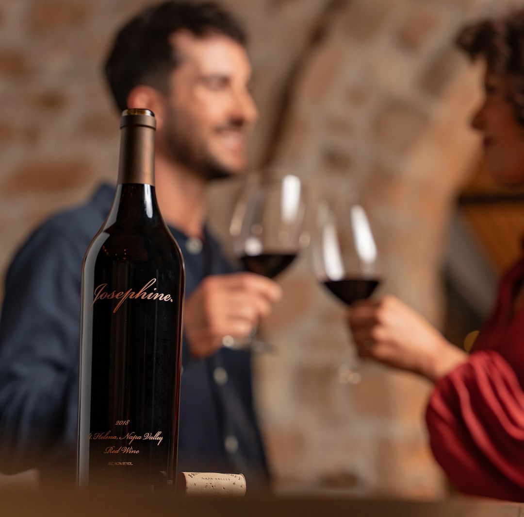 two people cheersing with the josephine red wine